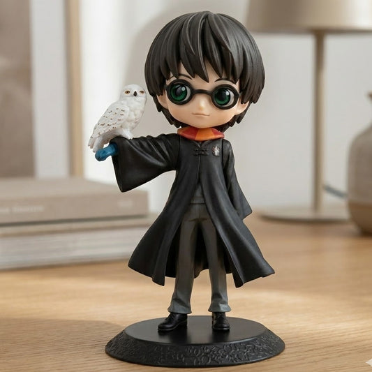Harry Potter (14cm) holding Hedwig, standing on a stack of spell books.